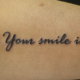筆記体「Your smile is」のタトゥー