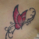 ピンク色の蝶とツタのタトゥー